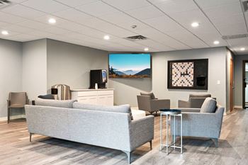 a living room with couches and chairs